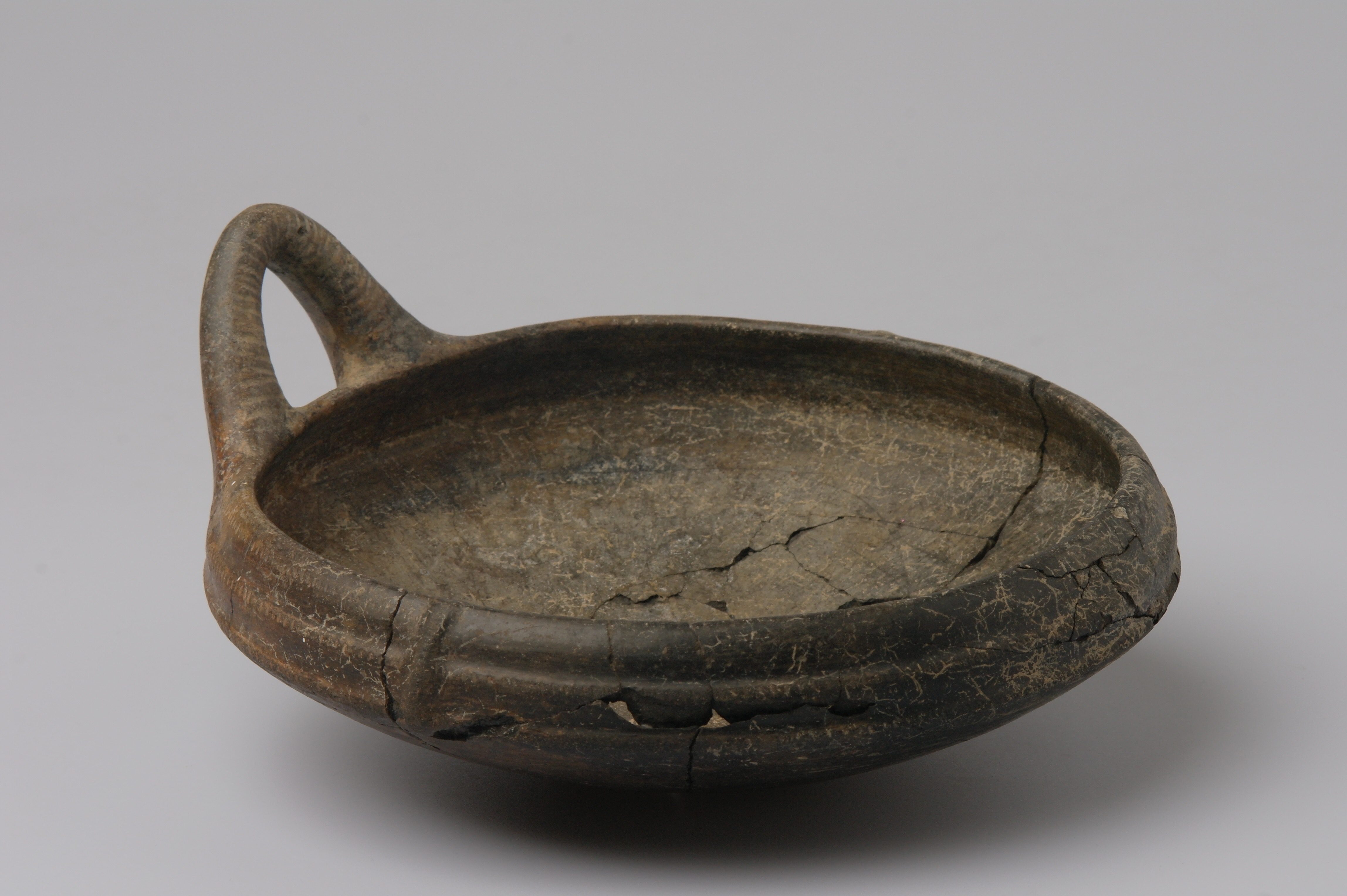 Cracked Etruscan pottery during conservation