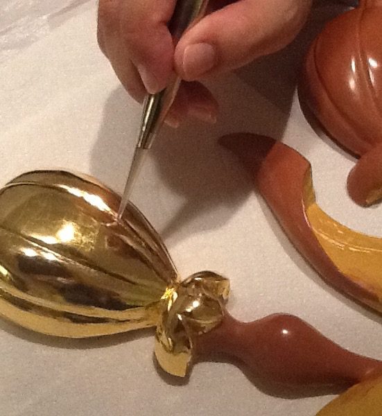 Wooden ornament during gilding conservation and burnishing