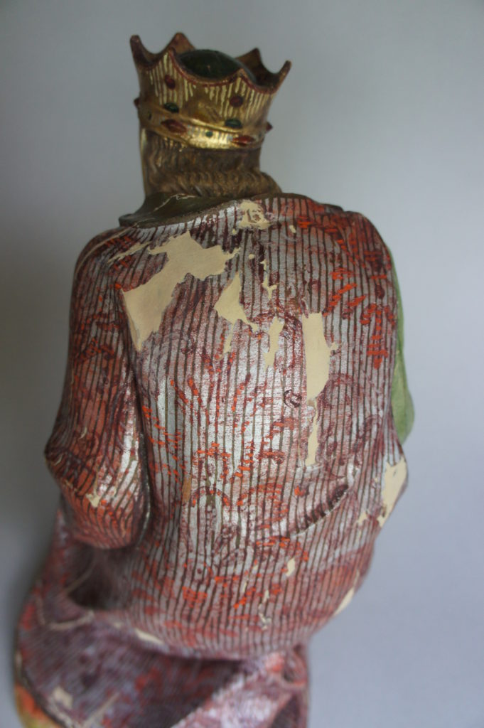 Back view of king during sculpture conservation