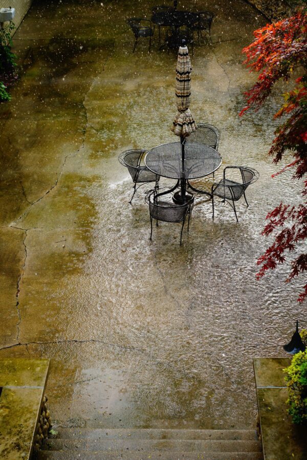 Aerial view of a terrace with chairs and table in the rain