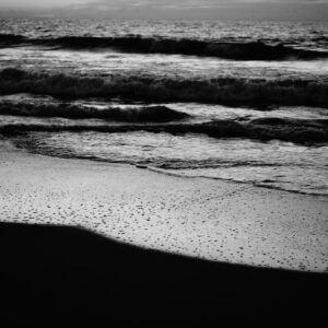 Black and White Image of The Waves and a shoreline