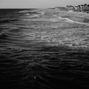 Black and White Photograph of a sea and houses